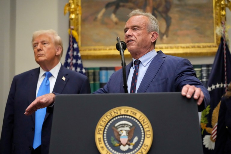 President Donald Trump listens as Health and Human Services Secretary Robert F. Kennedy Jr. speaks.