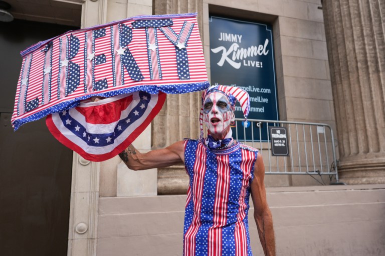 Dandidi of Los Angeles holds a sign that says 
