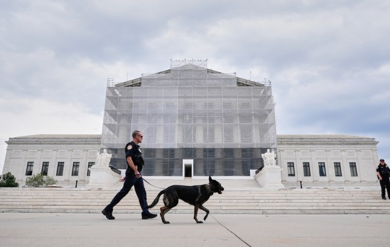 U.S. Capitol Police officers with a K9 detector dog, patrols outside of Supreme Court, Wednesday, Sept. 24, 2025, in Washington. (AP Photo/Mariam Zuhaib)