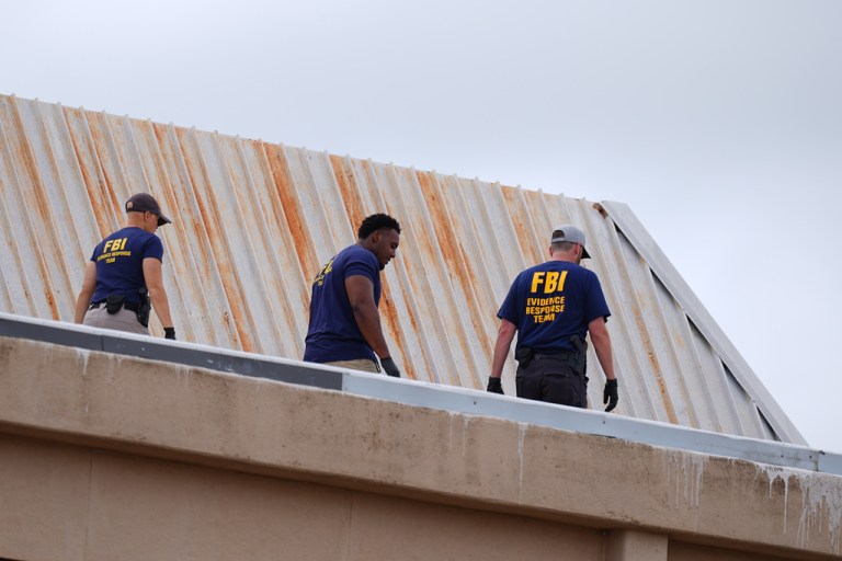 FBI agents walk on rooftop following Dallas ICE shooting.