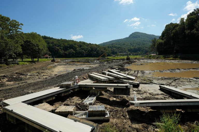 Workers cleanup debris and mud at Lake Lure, Wednesday, Sept. 17, 2025, near Chimney Rock, N.C.