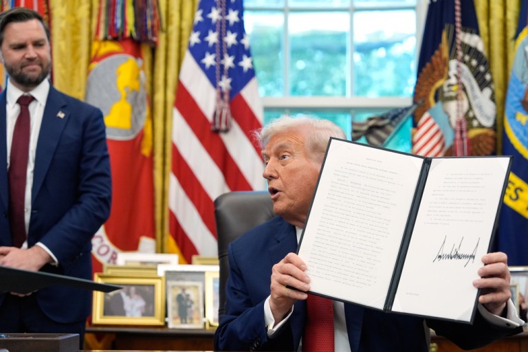 President Donald Trump holds a signed executive order regarding TikTok in the Oval Office at the White House, Thursday, Sept. 25, 2025, in Washington, as Vice President JD Vance watches.