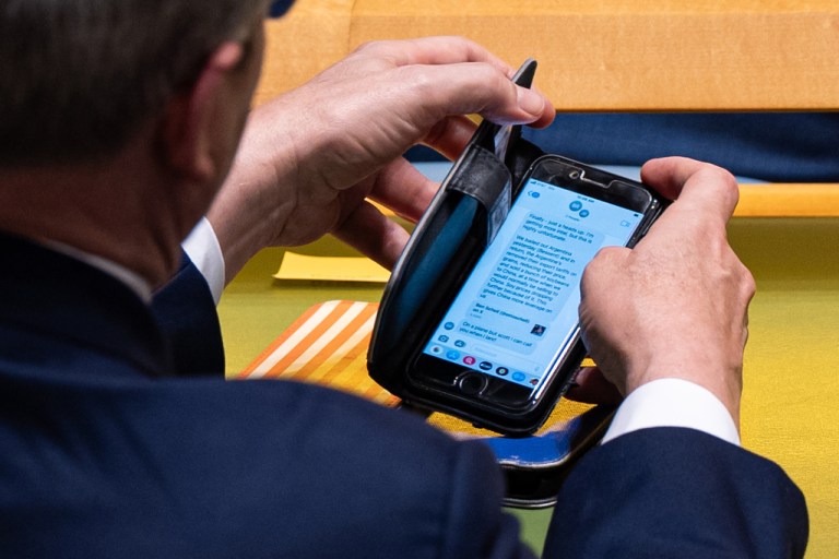 U.S. Treasury Secretary Scott Bessent checks a text message.