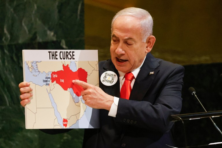 Israeli Prime Minister Benjamin Netanyahu holds up a map while speaking at the 80th session of the United Nations General Assembly.
