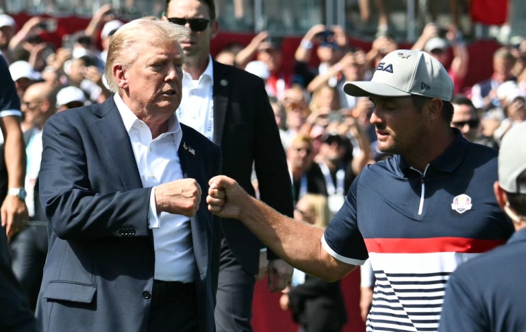 President Donald Trump, left, fist-bumps United States' Bryson DeChambeau as Trump attends the Ryder Cup golf tournament at Bethpage Black Golf Course in Farmingdale, N.Y., Friday, Sept. 26, 2025.