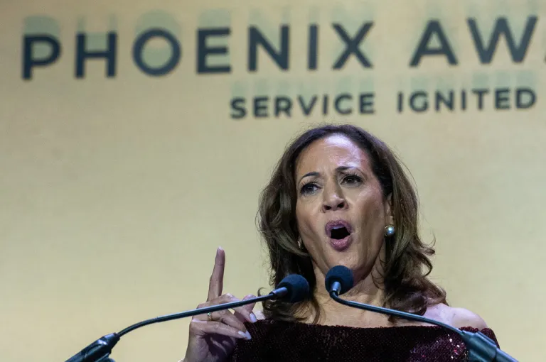 Kamala Harris speaks behind a podium and microphone