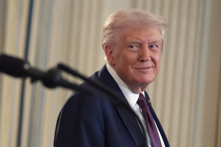 Trump smiles while looking to one side