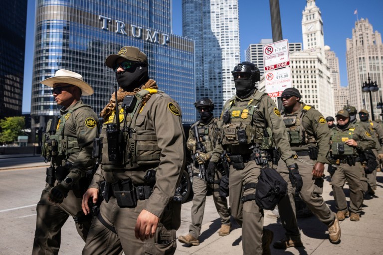 Federal agents from U.S. Immigration and Customs Enforcement and U.S. Customs and Border Protection walk along West Wacker Drive in the Loop, Sunday, Sept. 28, 2025, in Chicago.