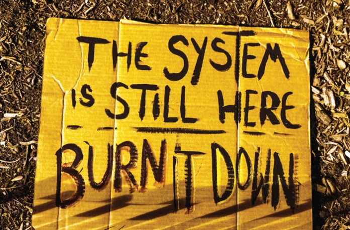 A sign discarded after a protest in Washington, D.C., April 20, 2021.