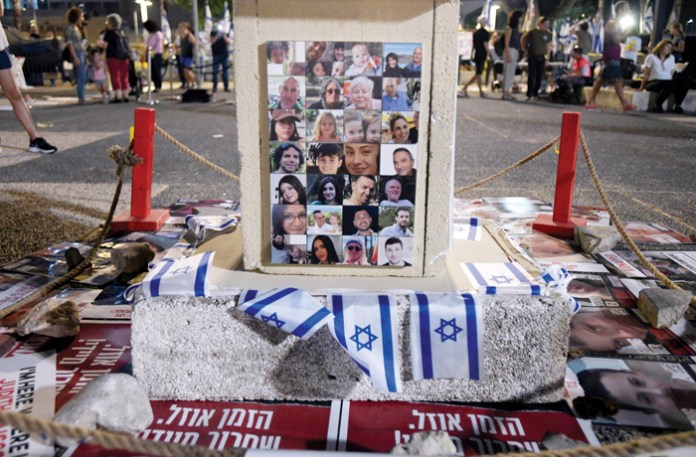 An altar with flags and portraits of the people kidnapped by Hamas on Oct. 7 is seen during a peaceful demonstration in Tel Aviv, Israel. (Photo by Israel Fuguemann/SOPA Images/LightRocket via Getty Images)