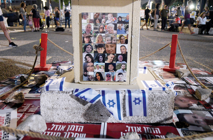 An altar with flags and portraits of the people kidnapped by Hamas on Oct. 7 is seen during a peaceful demonstration in Tel Aviv, Israel. (Photo by Israel Fuguemann/SOPA Images/LightRocket via Getty Images)