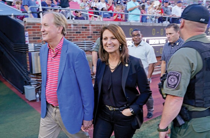 Republican Texas Attorney General Ken Paxton, left, with his then-wife, Republican Texas state Sen. Angela Paxton, at a football game in Dallas, Oct. 14, 2022. (LM Otero / AP)