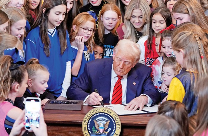 President Donald Trump signs an executive order barring transgender female athletes from competing in women’s or girls’ sporting events, Feb. 5, 2025. (Alex Brandon/AP)