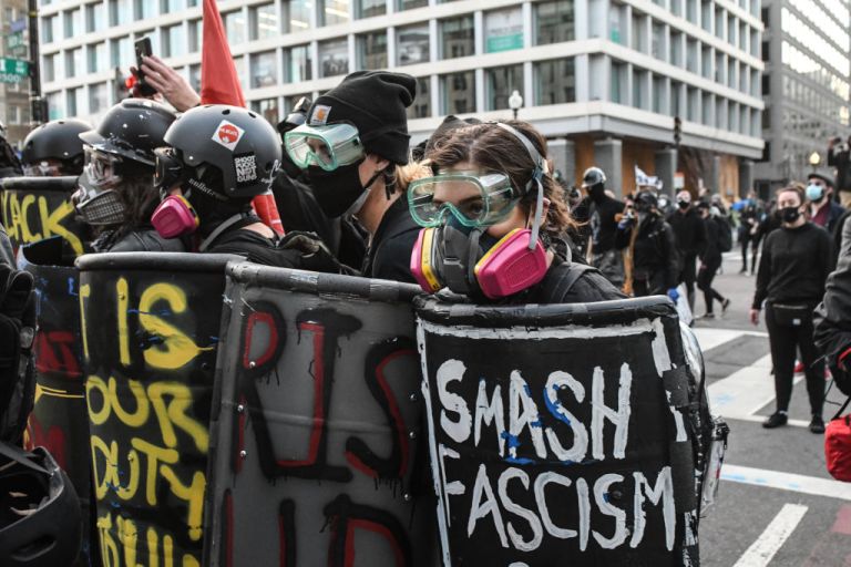 Members of Antifa hold shields during a protest at Black Lives Matter Plaza on December 12, 2020 in Washington, DC. Thousands of protesters who refuse to accept that President-elect Joe Biden won the election are rallying ahead of the electoral college vote to make Trump's 306-to-232 loss official. (Photo by Stephanie Keith/Getty Images)