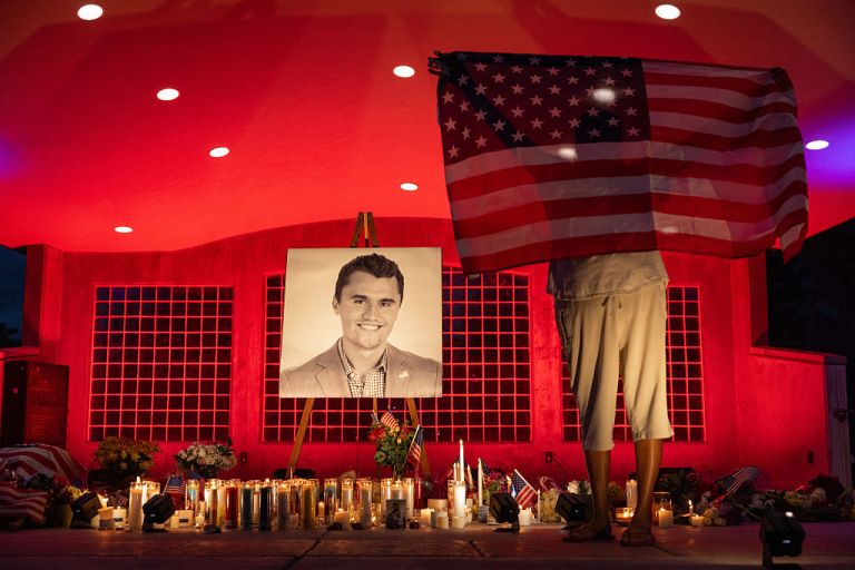 People pay their respects during a candlelight vigil for youth activist and influencer Charlie Kirk at a makeshift memorial at Orem City Center Park in Orem, Utah, a day after he was shot during a public event at Utah Valley University on September 11, 2025. The gunman who shot dead US right-wing youth leader Charlie Kirk in a targeted killing remained at large Thursday but authorities said they have video images of the suspect and have recovered a 