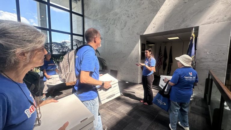 Our Revolution leaders delivering peititons.