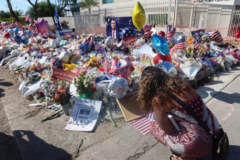 A young woman grieves at Charlie Kirk's makeshift memorial outside of Turning Point USA's headquarters in Phoenix. (Samantha-Jo Roth, Washington Examiner)