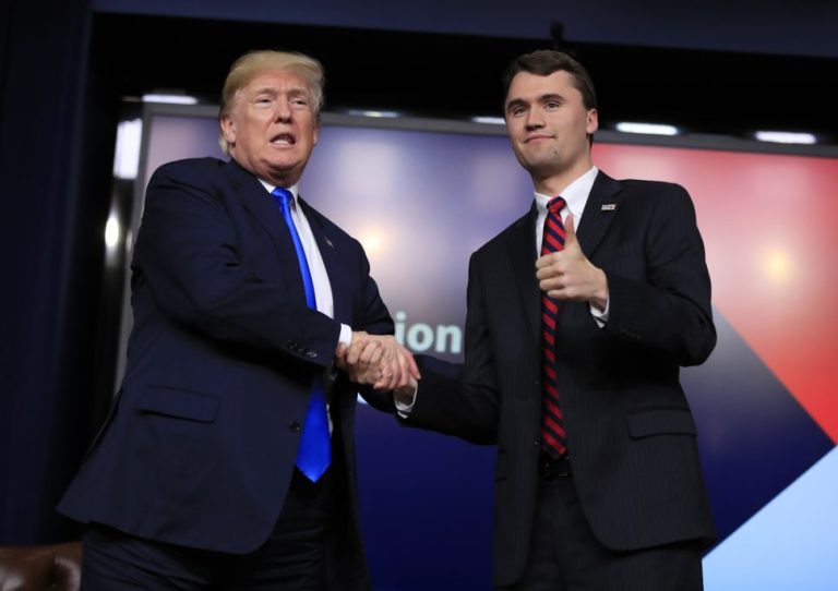 President Donald Trump shakes hands with Charlie Kirk.