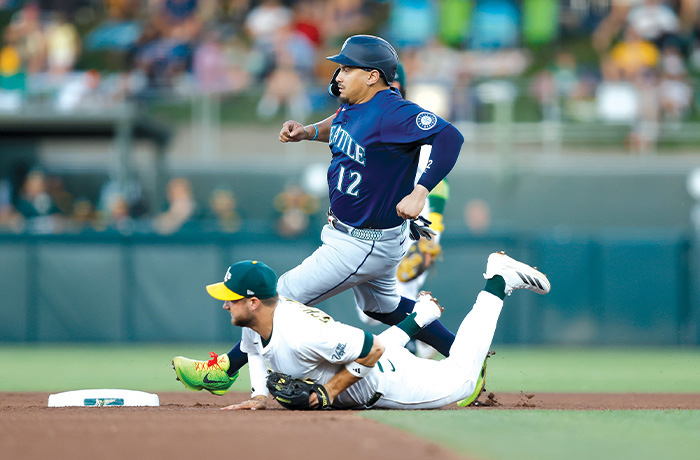 Josh Naylor of the Seattle Mariners steals second base as Max Schuemann of the Athletics is unable to field a throw in the top of the fourth inning on July 28 in Sacramento, California. (Lachlan Cunningham/Getty Images)