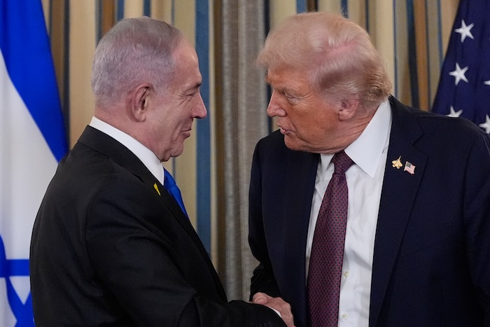 Israeli Prime Minister Benjamin Netanyahu shakes hands with President Donald Trump.