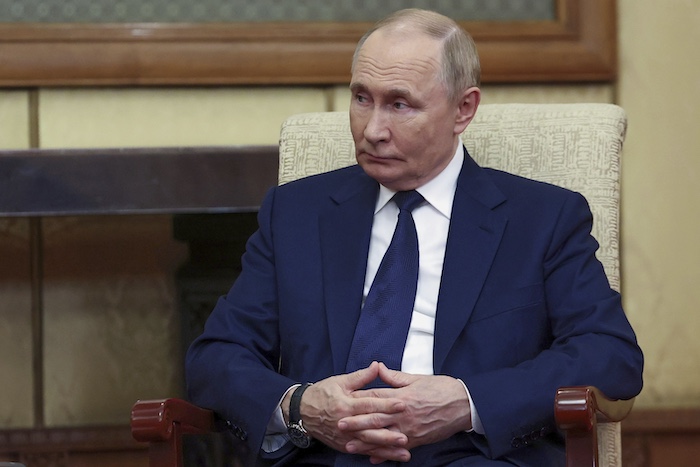 Russian President Vladimir Putin listens to Serbian President Aleksandar Vucic during their meeting at Diaoyutai State Guesthouse in Beijing, China, Tuesday, Sept. 2, 2025.
