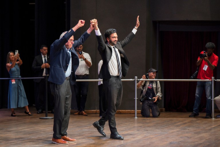 Sen. Bernie Sanders (I-VT) and New York City mayoral candidate Zohran Mamdani greet the crowd during a town hall
