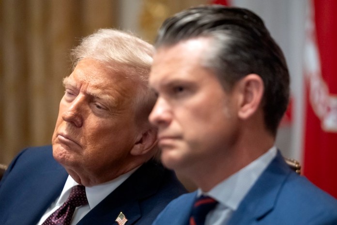 President Donald Trump, left, and Defense Secretary Pete Hegseth listen during a cabinet meeting at the White House, Tuesday, Aug. 26, 2025, in Washington.