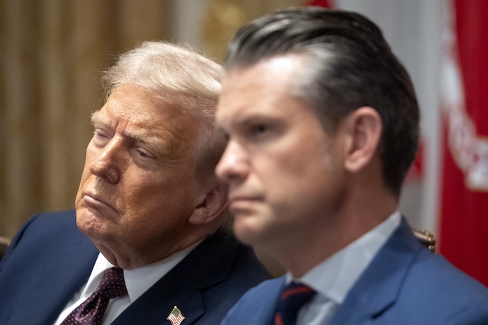 President Donald Trump, left, and Defense Secretary Pete Hegseth listen during a cabinet meeting at the White House, Tuesday, Aug. 26, 2025, in Washington.