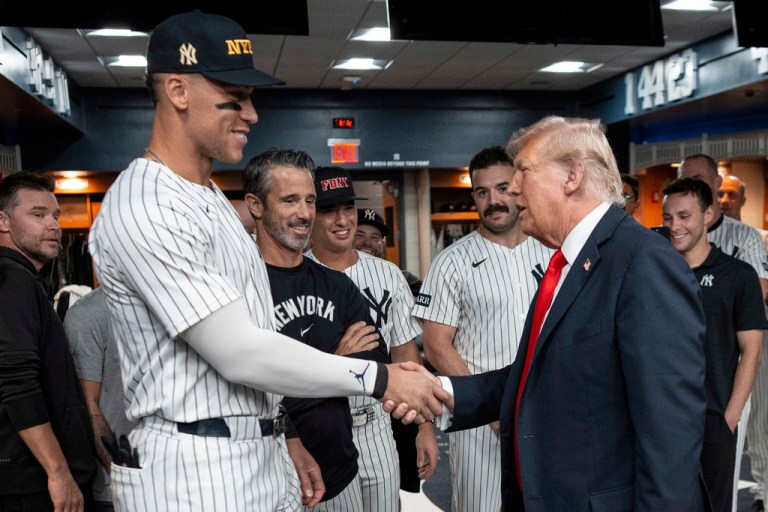 President Donald Trump shakes hands with New York Yankees Aaron Judge in the New York Yankees locker room before a baseball game against the Detroit Tigers, Thursday, Sept. 11, 2025, in New York. He was there for a 9/11 memorial game.