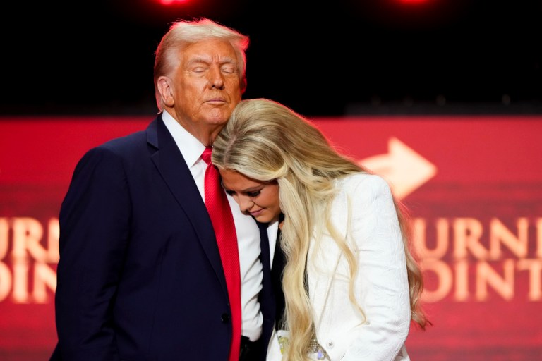 President Donald Trump hugs Erika Kirk.