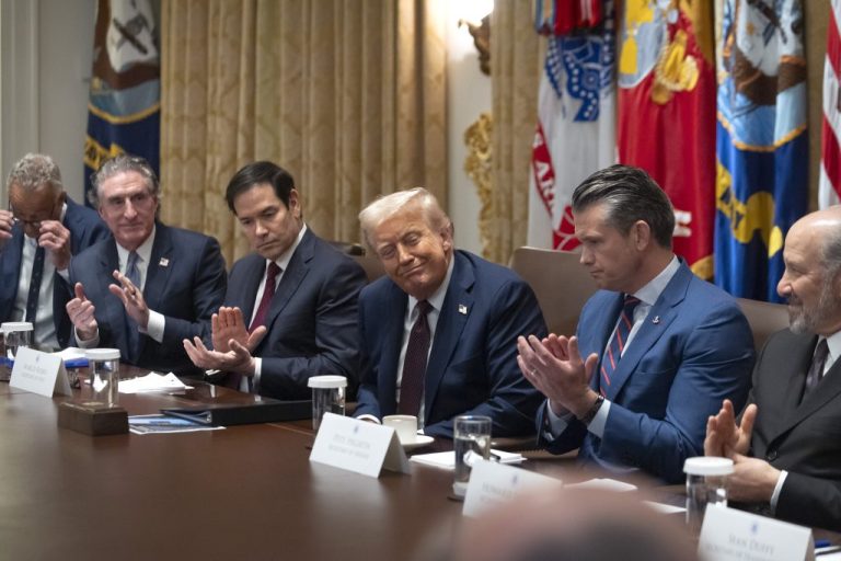 President Donald Trump sitting with his cabinet members