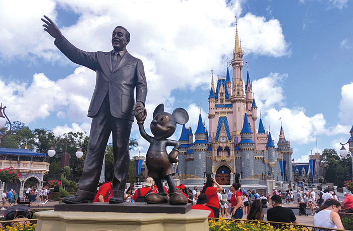 A statue of Walt Disney and Mickey Mouse in front of Cinderella's Castle at Walt Disney World in Orlando, Florida. (Photo by Gary Hershorn/Getty Images)