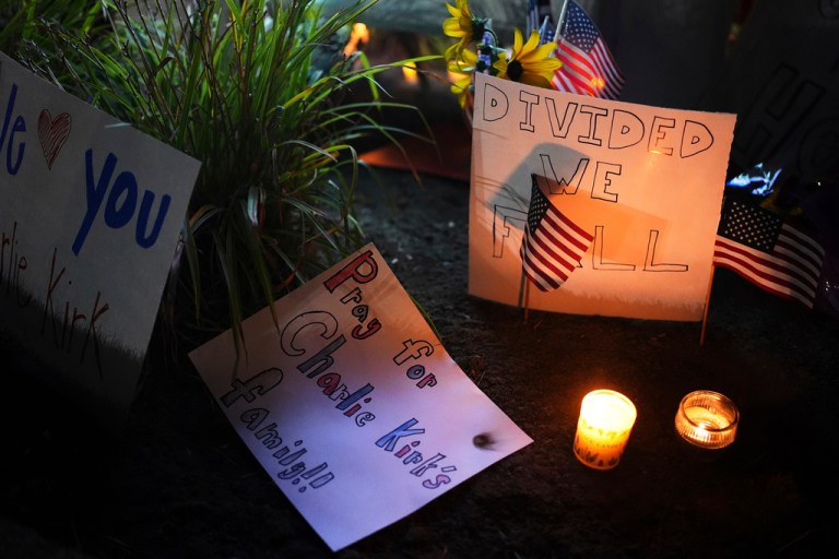 Signs at a vigil for Charlie Kirk.