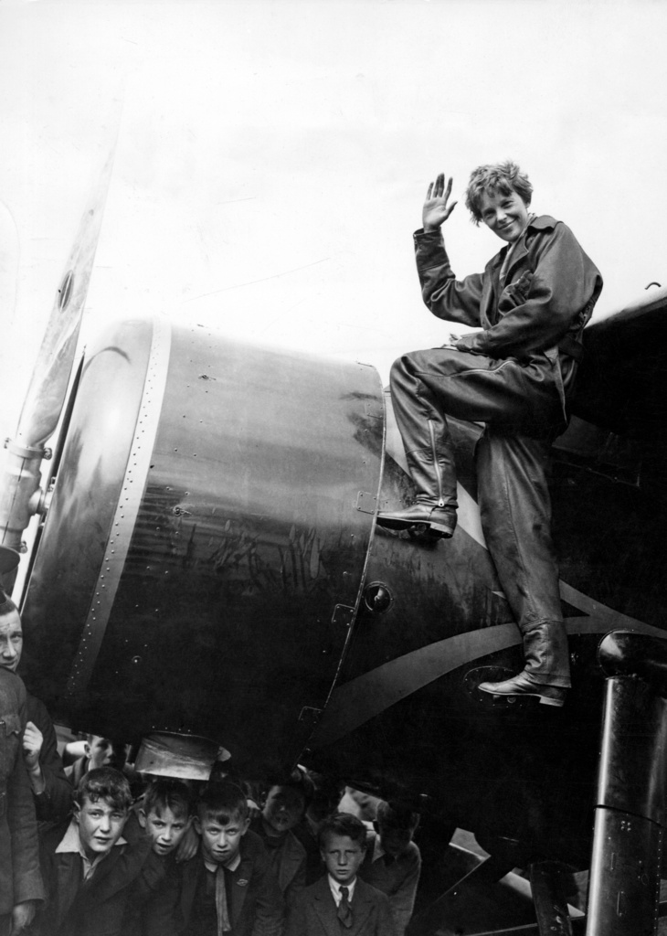 Amelia Earhart poses on plane