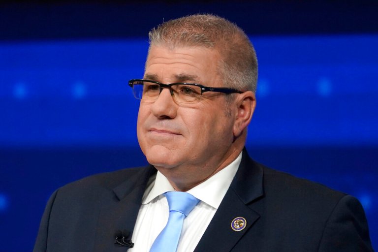Darren Bailey stares ahead with a dark suit and a light blue tie.