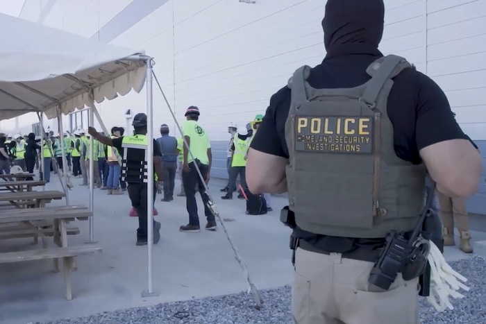 Manufacturing plant employees being escorted outside the Hyundai Motor Group’s electric vehicle plant.