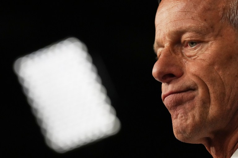 Senate Majority Leader John Thune grimaces.