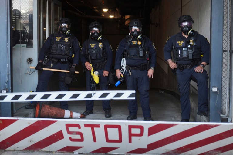 Department of Homeland Security police officers stand during a protest after federal immigration authorities conducted an operation on Friday, June 6, 2025, in Los Angeles.