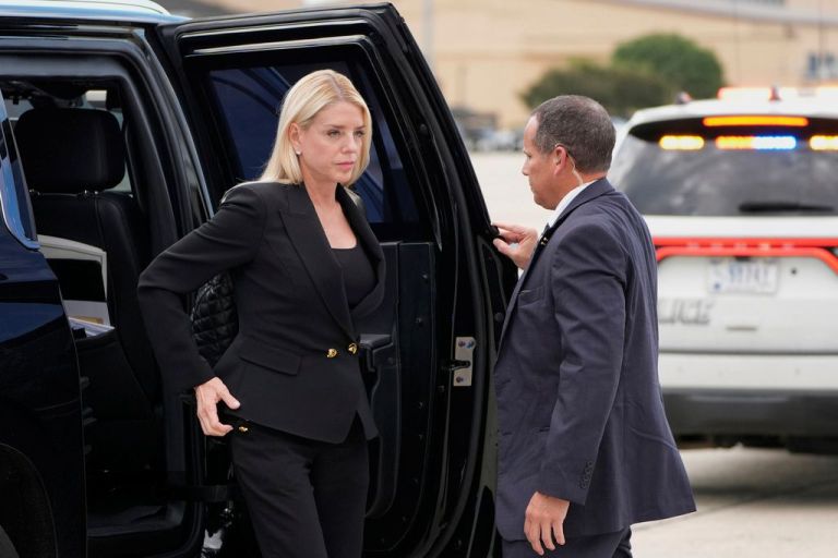Pam Bondi exits a vehicle before boarding Air Force One.