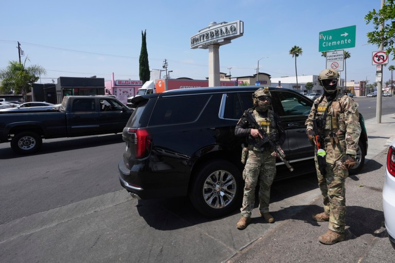 Immigration agents conduct an operation at a car wash on Aug. 15, 2025, in Montebello, California.