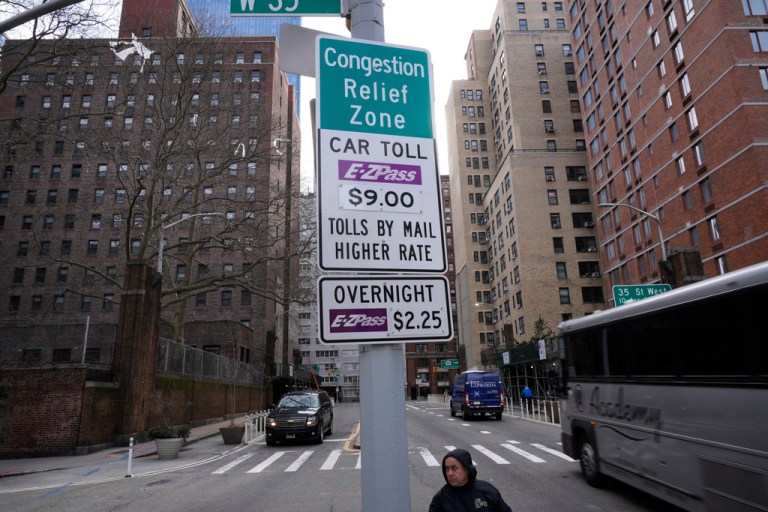 Signs advising drivers of congestion pricing tolls are displayed near the exit of the Lincoln Tunnel in New York, Wednesday, Feb. 19, 2025. (AP Photo/Seth Wenig, File)