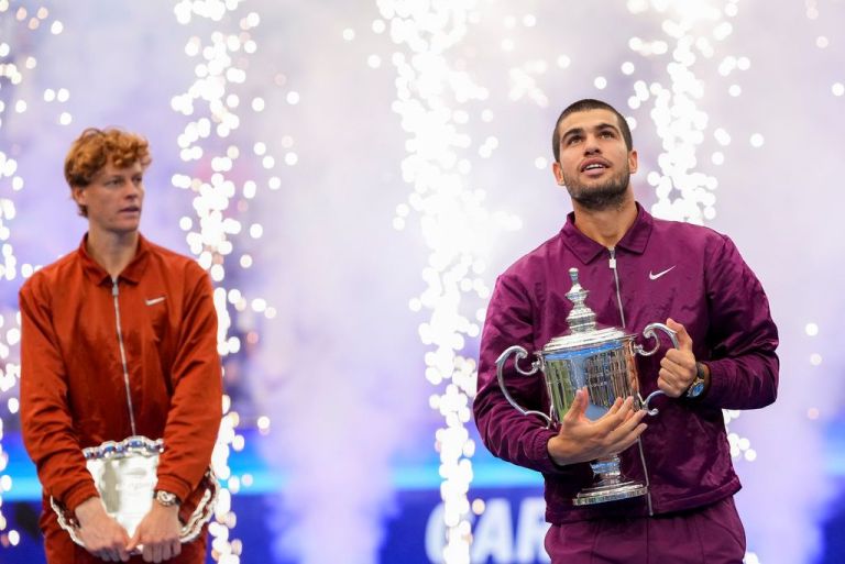 Carlos Alcaraz holds US Open trophy next to Jannik Sinner
