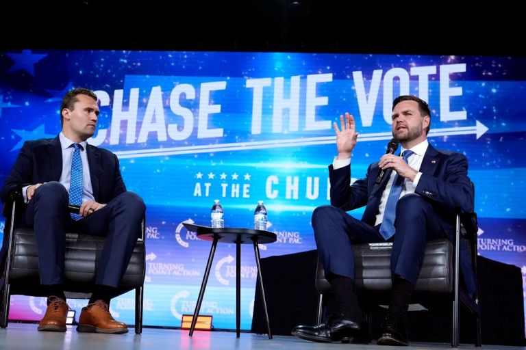 Republican vice presidential nominee Sen. JD Vance, R-Ohio, right, speaks at a campaign event as Turning Point USA Founder Charlie Kirk, left, listens Wednesday, Sept. 4, 2024, in Mesa, Ariz. (AP Photo/Ross D. Franklin)