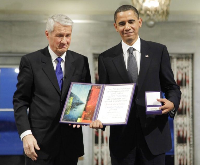 President Barack Obama holds his Nobel Peace Prize in 2009.