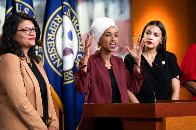 Rep. Ilhan Omar (D-MN), flanked by Rep. Rashida Tlaib (D-MI) and Rep. Alexandria Ocasio-Cortez (D-NY), speaks at a news conference.