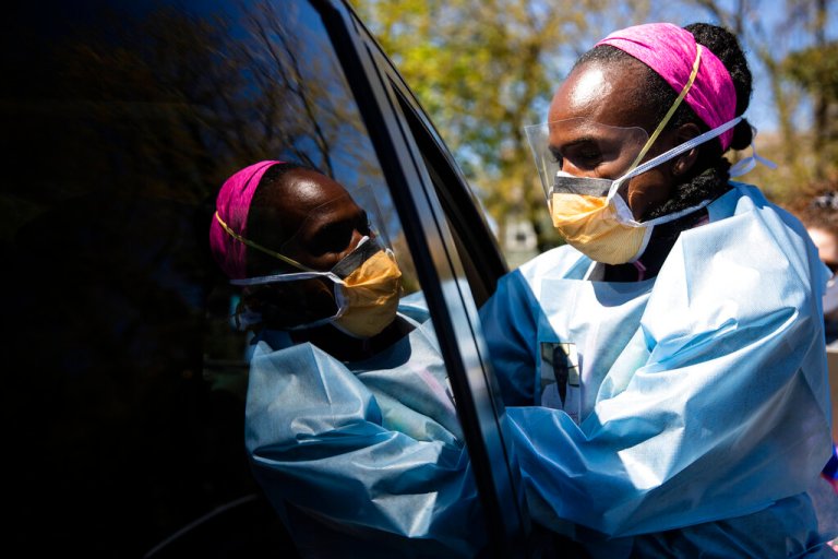 Dr. Ala Stanford administers a COVID-19 swab test on a person in the parking lot of Pinn Memorial Baptist Church in Philadelphia, Wednesday, April 22, 2020. Stanford and other doctors formed the Black Doctors COVID-19 Consortium to offer testing and help address heath disparities in the African American community.