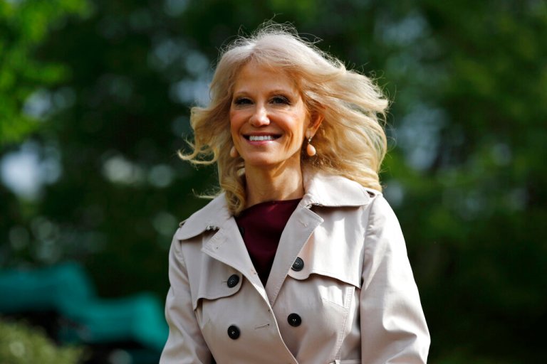 Kellyanne Conway walks outside the White House.