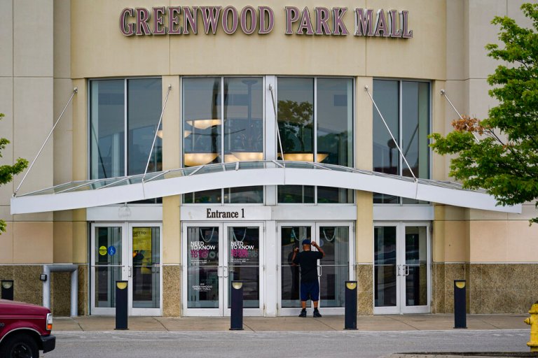 A customer checks a door on the closed Greenwood Park Mall in Greenwood, Indiana.