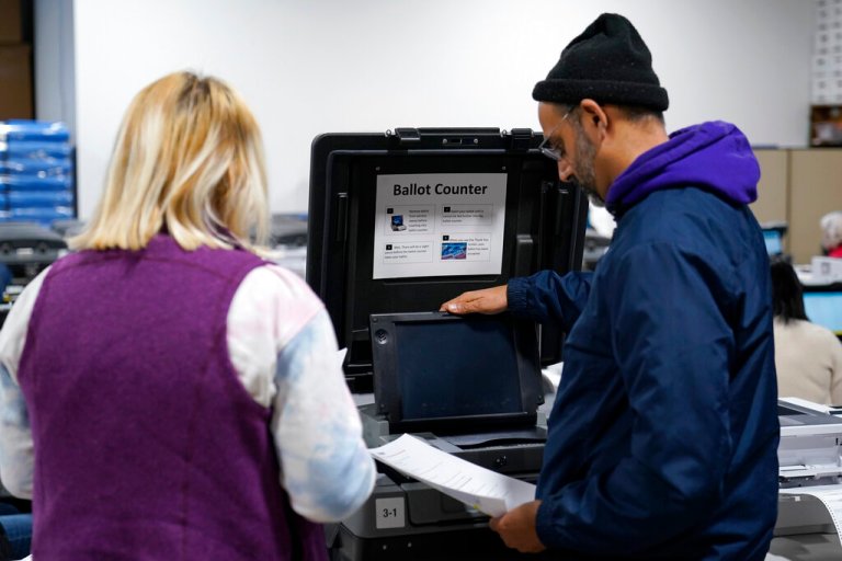 Election judges demonstrate the accuracy of the city's voting equipment on Friday, Oct. 28, 2022, in Minneapolis. Before any election, the state's law requires the city's voting machines to be publicly tested for accuracy. (AP Photo/Abbie Parr)