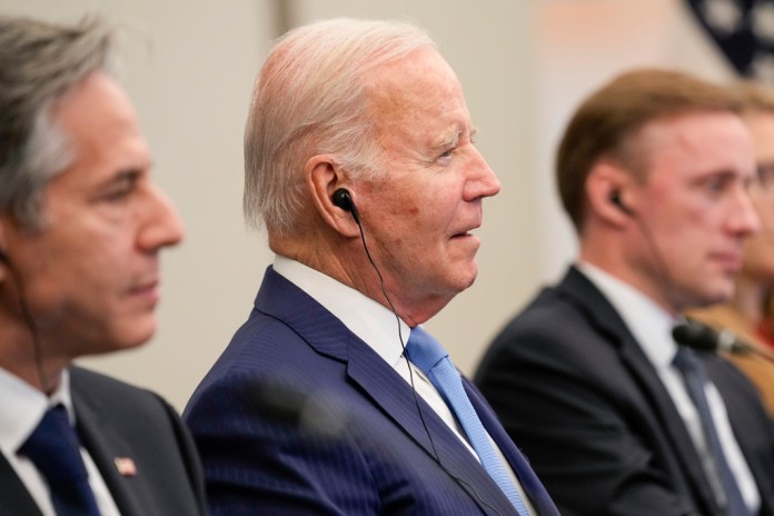 President Joe Biden, center, sits with Secretary of State Antony Blinken, left, and National Security Advisor Jake Sullivan.
